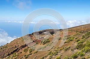 Beautiful volcanic landscape above clouds with mountain vegetation, winding road and view points.Teide National Park, Tenerife,