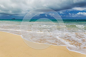 Beautiful Waimanalo beach with turquoise water and cloudy sky