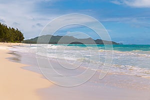 Beautiful Waimanalo beach with turquoise water and cloudy sky