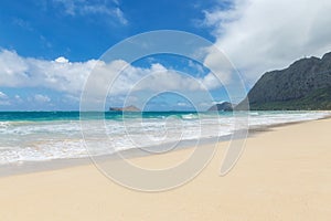 Beautiful Waimanalo beach with turquoise water and cloudy sky, Oahu coastline