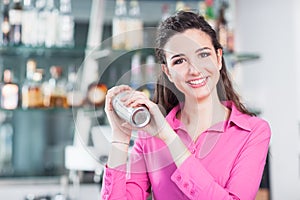 Beautiful waitress with cocktail shaker