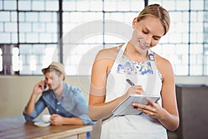 A beautiful waitress taking an order