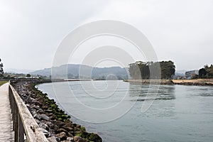 Beautiful walking path next to the river at Rodiles, Asturias,