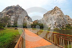 Beautiful walkway with rocky mountain background of khao Ngu Stone Park , Ratchaburi , Thailand.