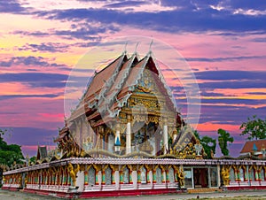 Beautiful Wat Buddhist temples in Phuket Thailand. Decorated in beautiful ornate colours of red and Gold and Blue. Lovely sunset