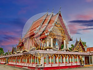 Beautiful Wat Buddhist temples in Phuket Thailand. Decorated in beautiful ornate colours of red and Gold and Blue. Lovely sunset