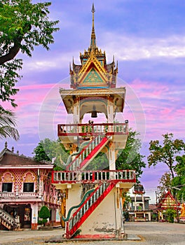 Beautiful Wat Buddhist temples in Phuket Thailand. Decorated in beautiful ornate colours of red and Gold and Blue. Lovely sunset