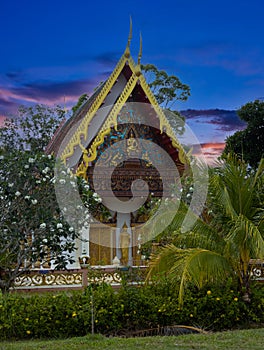 Beautiful Wat Buddhist temples in Phuket Thailand. Decorated in beautiful ornate colours of red and Gold and Blue. Lovely sunset