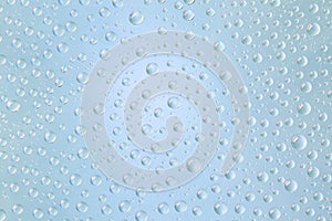 Beautiful water droplets of regular shape on frosted glass photo
