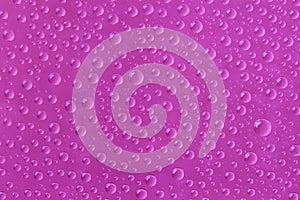 Beautiful water drops of the correct form on a pink background