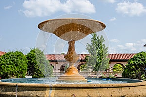 Beautiful water fountain in a flower garden