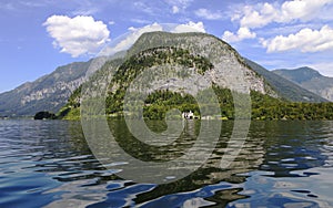 Beautiful water landscape with small white castle in tHallstaetter lake, Hallstatt, Upper Austria