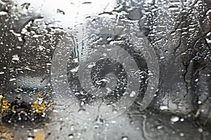 Beautiful water texture. Raindrops on the glass on a dark background. Abstract background. The texture of dripping water