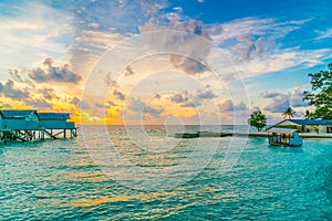 Beautiful water villas in tropical Maldives island at the sunset