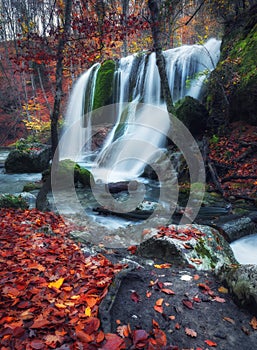 Beautiful waterfall in autumn forest in crimean mountains at sun