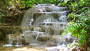 Beautiful waterfall cascade landscape. Amazing fairy waterfall among green tropical jungle in summer sunny day