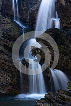 Beautiful waterfall cascading down cliff and boulders in Australian high country