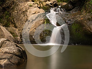 Beautiful waterfall in Covasna County framed by green moss and vegetation