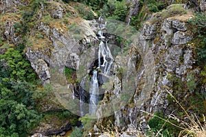 Beautiful waterfall falling from a mountain on a mountain river
