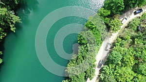 Beautiful waterfall in green forest, top view. River in a canyon, aerial drone Big Waterfall.