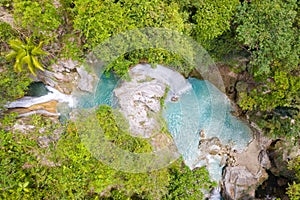 Beautiful waterfall in green forest, top view. Tropical Inambakan Falls in mountain jungle, Philippines, Cebu. Waterfall in the