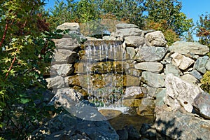 Beautiful waterfall in Japanese garden. Public landscape park of Krasnodar or Galician park, Russia