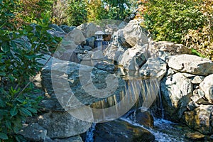Beautiful waterfall in Japanese garden. Public landscape park of Krasnodar or Galician park, Russia