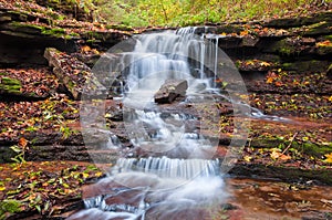 Beautiful waterfall on a mountain stream in the woods