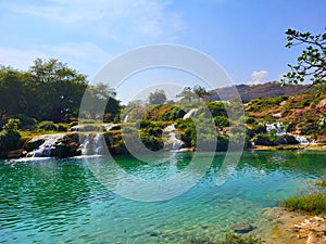 Beautiful waterfall in an oasis of Oman. Wadi Darbat