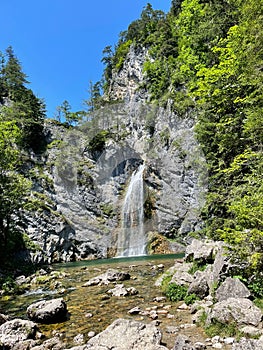 beautiful waterfall on rock in forest photo