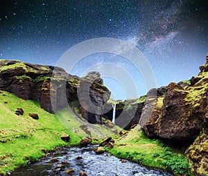 Beautiful waterfall. The starry sky and the Milky Way. Iceland.