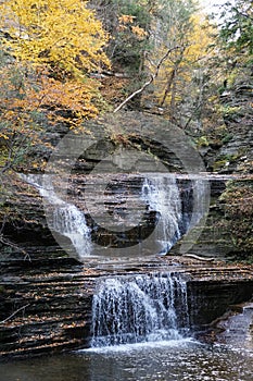 Beautiful waterfalls from above the hills with the background of fall foliage near Buttermilk Falls, Ithaca, New York, U.S