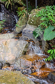 The beautiful waterfalls, rapids and mountain streams in the tropical forest in Yanoda Park,  Sanya city. Hainan, China