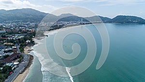 Beautiful wave crashing on sandy shore at patong beach in phuket thailand,aerial view drone shot High angle view