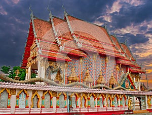 beautiful Way Buddhist temples in Phuket Thailand. Decorated in beautiful ornate colours of red and Gold and Blue. Lovely sunset