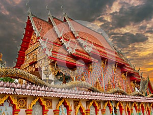 beautiful Way Buddhist temples in Phuket Thailand. Decorated in beautiful ornate colours of red and Gold and Blue. Lovely sunset