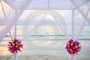 Beautiful wedding arch on the beach .