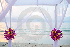 Beautiful wedding arch on the beach .