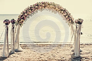 Beautiful wedding arch on the beach photo