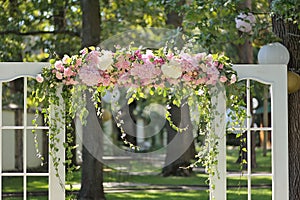 Beautiful wedding arch, decorated with roses and peons, closeup
