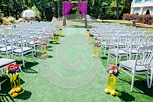 Beautiful wedding archway with chairs on on each side