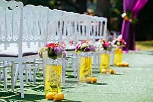 Beautiful wedding archway with chairs on on each side