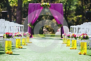 Beautiful wedding archway with chairs on on each side