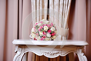 Beautiful wedding boquet lying on table in restaurant