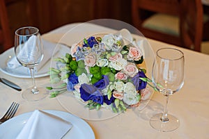 Beautiful wedding boquet lying on table in restaurant