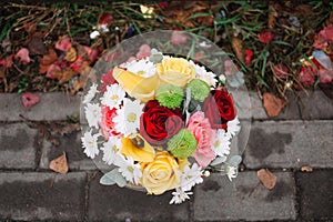 Beautiful wedding bouquet against the background of asphalt