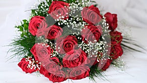Beautiful wedding bouquet of bride red roses and gypsophila