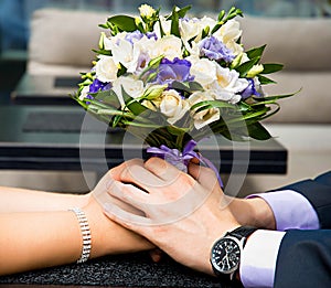 Beautiful wedding bouquet in brides and grooms hands