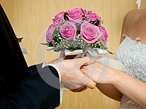 Beautiful wedding bouquet in brides and grooms hands photo