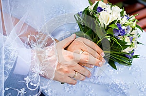 Beautiful wedding bouquet in brides and grooms hands photo